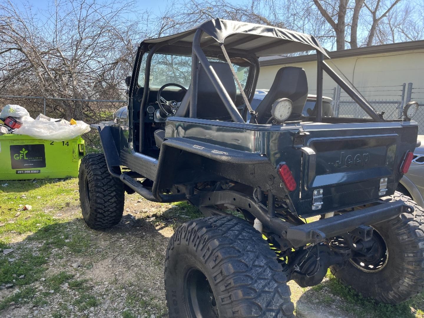 1985 BLACK JEEP CJ7 Laredo (1JCCF87E4FT) with an 4.2L L6 OHV engine, AUTOMATIC transmission, located at 2303 West Mt. Houston, Houston, 77038, (281) 507-3956, 29.771597, -95.339569- Photo#2