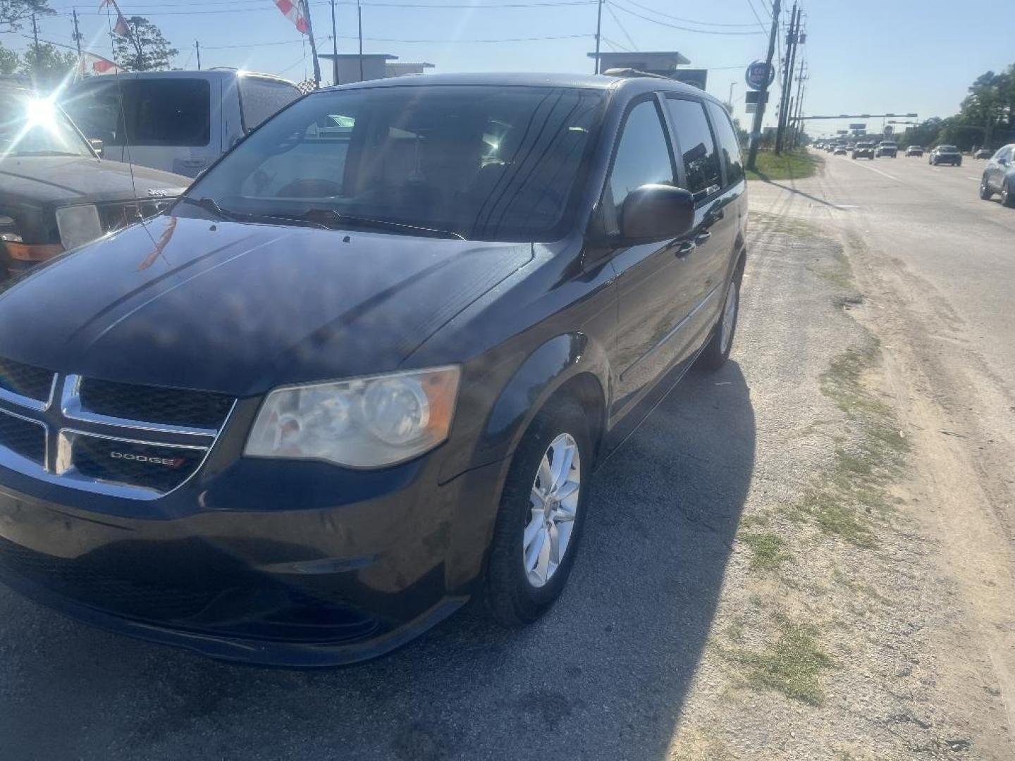 2014 BLACK DODGE GRAND CARAVAN SXT (2C4RDGCG6ER) with an 3.6L V6 DOHC 24V engine, AUTOMATIC transmission, located at 2303 West Mt. Houston, Houston, 77038, (281) 507-3956, 29.771597, -95.339569 - Photo#1