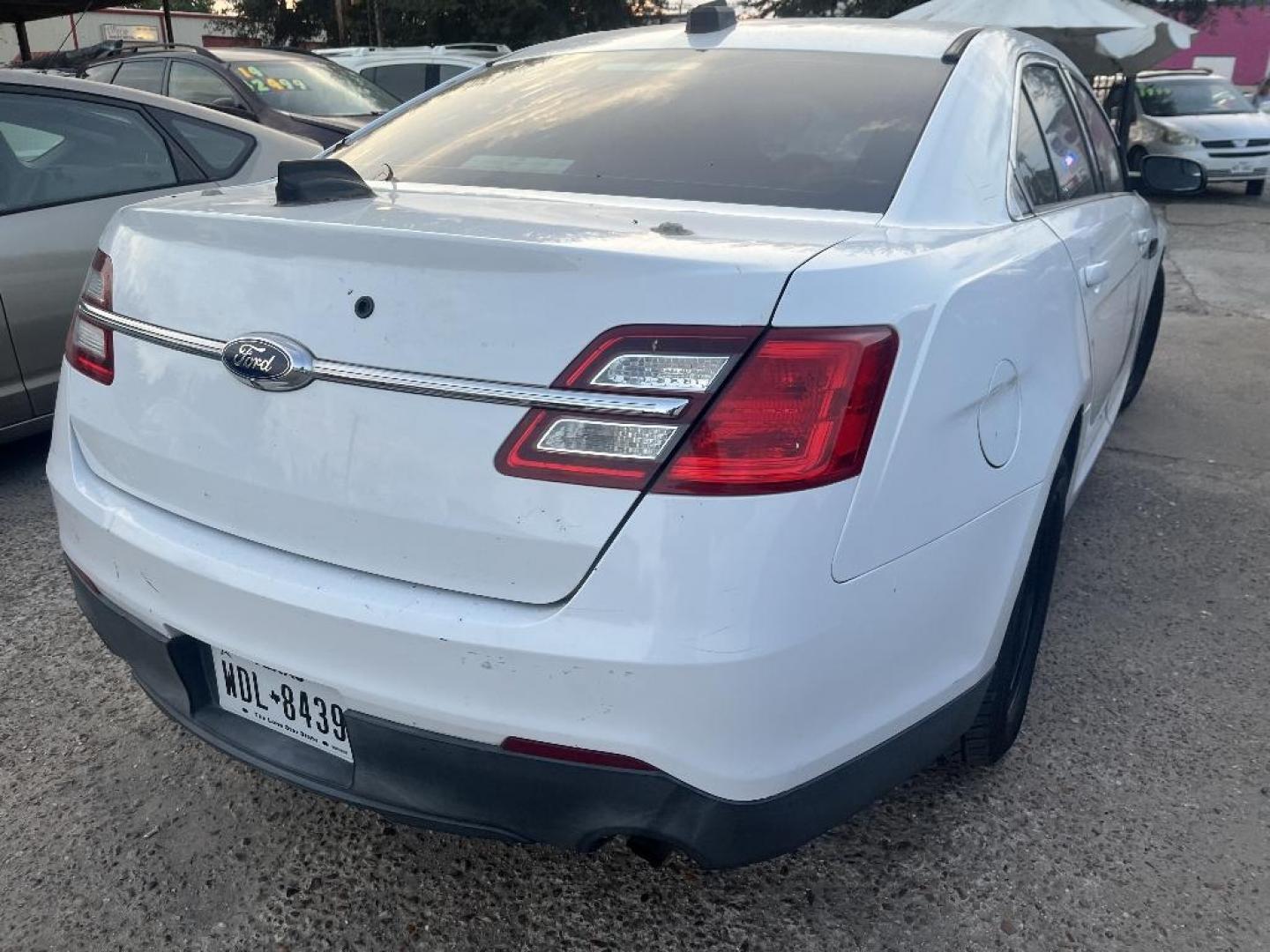 2015 WHITE FORD TAURUS Police AWD (1FAHP2MK7FG) with an 3.7L V6 DOHC 24V engine, AUTOMATIC transmission, located at 2303 West Mt. Houston, Houston, 77038, (281) 507-3956, 29.771597, -95.339569 - Photo#1
